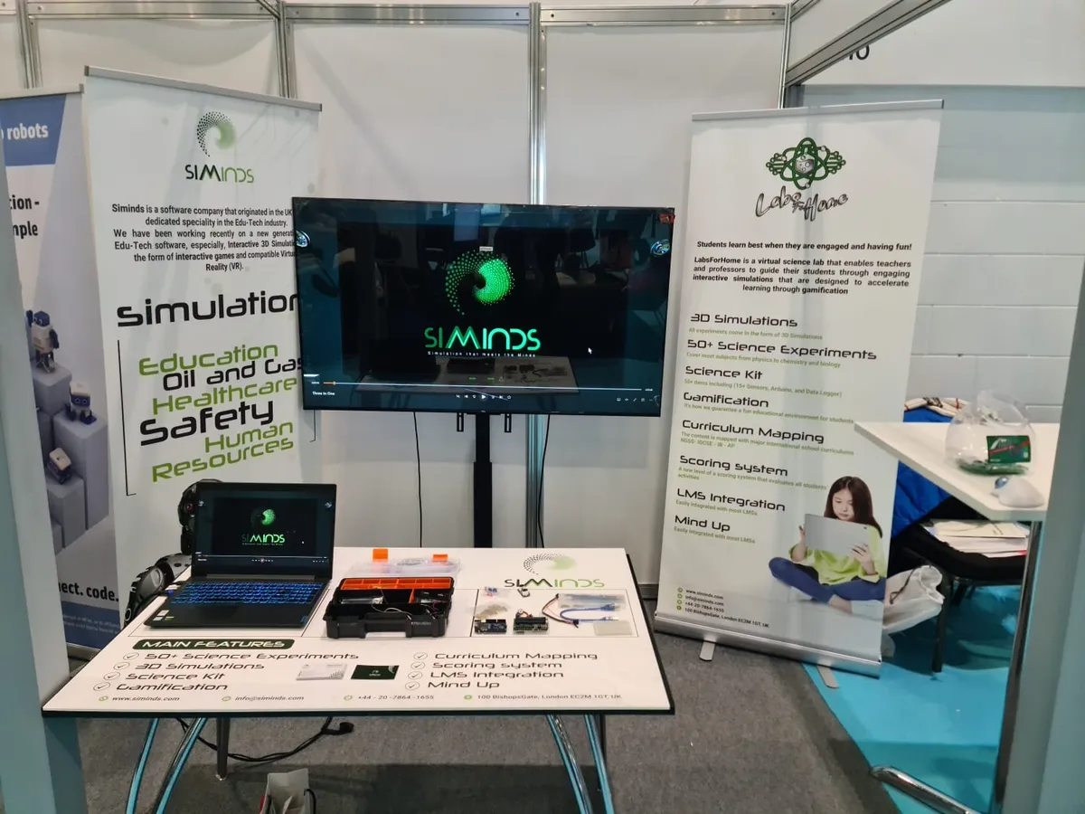 The Siminds and Labs For Home stand at the BETT Show 2023 in London, with a screen and the science kit on the table